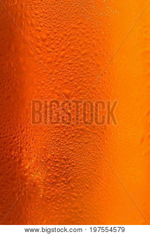 Beer. Beautiful detail of beaten glass of beer with foam. Abstract colorful background.