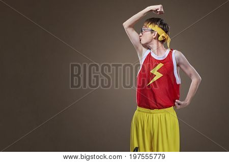 A very thin guy in sports clothes kisses his hand. Concept of sport.