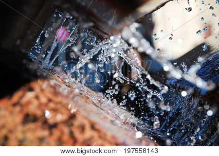 Abstract Water splashes from a brown fountain