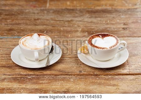 A cup of latte coffee top view on old wood background.