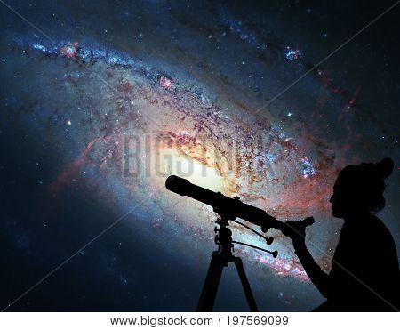 Girl Looking At The Stars With Telescope. Spiral Galaxy M106, In The Constellation Canes Venatici. .