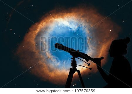 Girl Looking At The Stars With Telescope. The Helix Nebula Or Ngc 7293 In The Constellation Aquarius