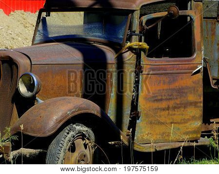 The front engine area and cab of a vintage old truck.