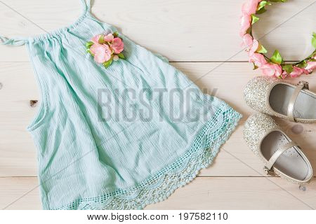 Girl's Dress, Floral Tiara And Shiny Shoes On A Wooden Background.