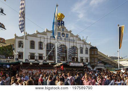 Munich, Germany - September 24, 2016: Facade and entrance of the Hofbraeu beer tent with unidentified people standing in front