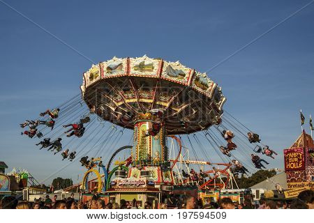 Munich, Germany - September 24, 2016: Carousel in motion with people flying through the air on Theresienwiese