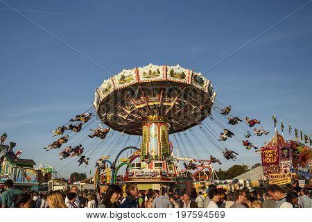 Munich, Germany - September 24, 2016: Carousel in motion with people flying through the air on Theresienwiese