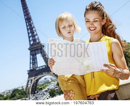 Having fun time near the world famous landmark in Paris. smiling mother and child travellers exploring attractions in Paris France