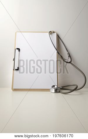stethscope and blank clipboard