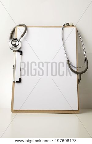stethscope and blank clipboard
