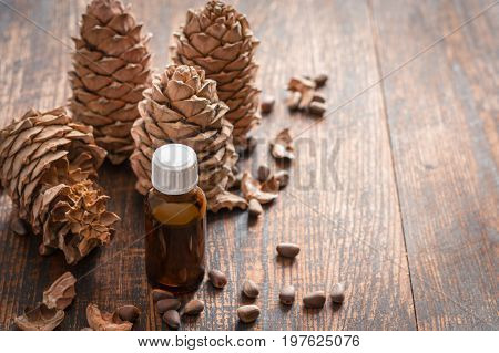 Esential Cedar Oil and Nuts selective focus.