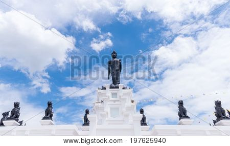 Black Big Buddha Statue With White Cloudy And Blue Sky