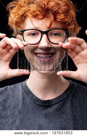 Smile Of A Girl In Braces Through A Transparent Mobile Phone