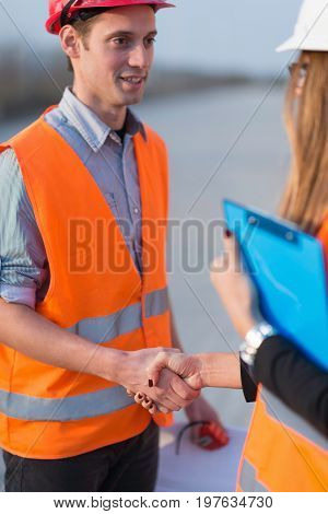 Handhaking On Construction Site, Color Image, Indoors