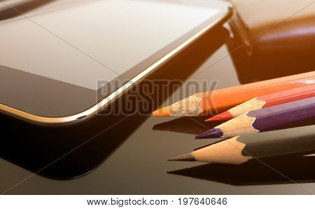 Tablet, pencil and wallet on officedesk.technology or education background.