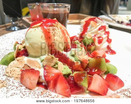 Fruit ice cream fudge consists of kiwi strawberry and chocolate sauce. Strawberry sauce