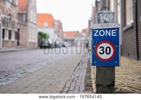 Sign zone of maximum speed 30 on old town street