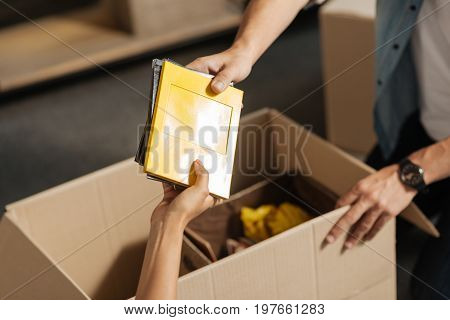 My albums. Young people collecting their things while going to remove their apartment