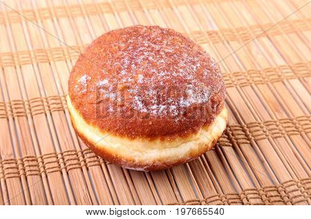 Homemade Doughnuts with Jelly filled and powdered sugar on Bamboo tablecloth. Selective focus