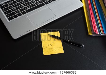 Business computer with note paper on table