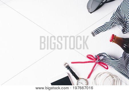 Retro Style Striped Swimsuit And Fashion Accessories  On A White Concrete Background