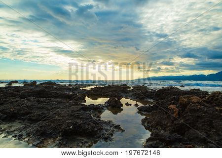 Sunset with clouds and sea waves, Crete, Greece