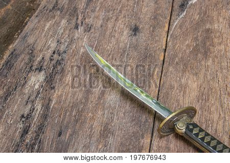 sword steel blade samurai ancient on old wooden surface floor with copy space
