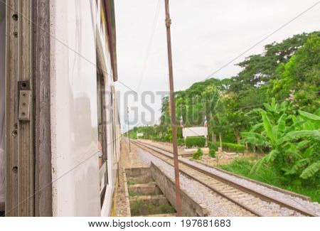 window old of train run travel in countryside. select focus with shallow depth of field and blurred background
