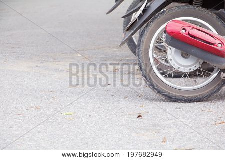 motorcyle wheel dirty parked in public park on the road with copy space add text