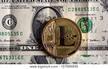 Golden  litecoin on one dollar banknote - cryptocurency traiding concept