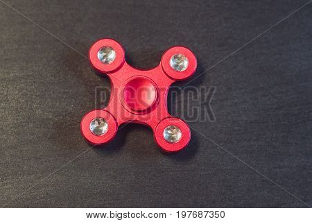Famous Fidget Spinner Stress Relieving N A Black Wooden Background