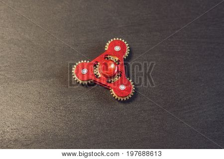Famous Fidget Spinner Stress Relieving N A Black Wooden Background