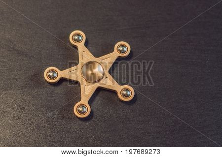 Famous Fidget Spinner Stress Relieving N A Black Wooden Background