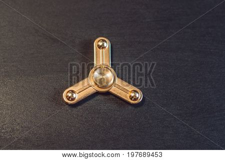Famous Fidget Spinner Stress Relieving N A Black Wooden Background