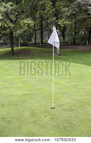 White Golf Flag On A Field