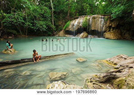 KANCHANABURI THAILAND - JUNE 24: People traveling and bath in Erawan waterfall Thailand on June 24 2017