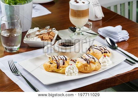 Eclairs with the dark hot chocolate and beze