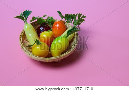 Ball plated thai dessert on pink background, Mold from steamed beans is a fruits shape.