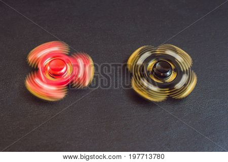 Famous Fidget Spinner Stress Relieving N A Black Wooden Background