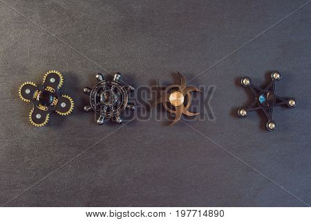 Famous Fidget Spinner Stress Relieving N A Black Wooden Background