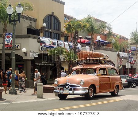 HUNTINGTON BEACH, CA:  JULY 2017.  A vintage station wagon cruises Main Street in Huntington Beach, California.