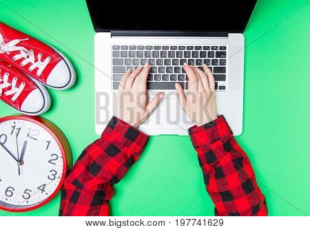Female Hands And Huge Clock With Gumshoes Near Laptop