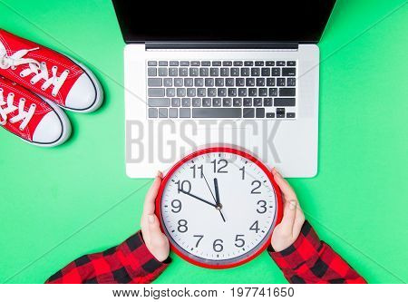 Female Hands And Huge Clock With Gumshoes Near Laptop