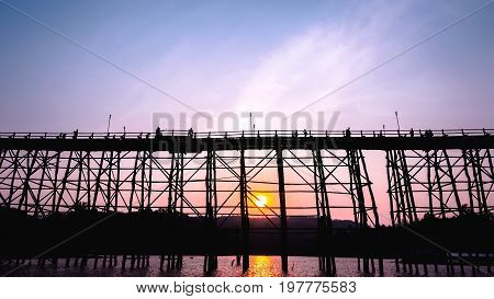 Silhouetted bridge at sunset in Sangkla Thailand