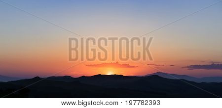 Sunset in the silhouette hills beautiful panorama