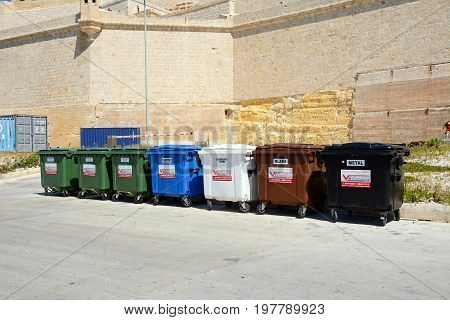VITTORIOSA, MALTA - MARCH 31, 2017 - Seven recycling bins outside Fort Saint Angelo Vittoriosa (Birgu) Malta Europe, March 31, 2017.
