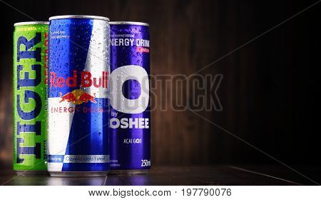 POZNAN POLAND - JULY 27 2017: Cans of popular global energy drinks beverages containing stimulant drugs and marketed as providing mental and physical stimulation