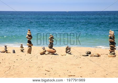 Stones Piled On Top Of One Another In Inuksuk Fashion