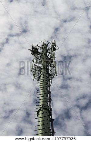 antenna supporting tower with white cloudy sky