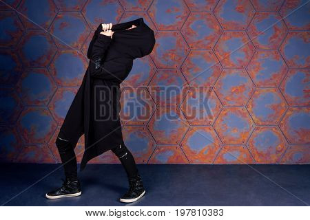 Young dancer dancing near the wall. Urban style